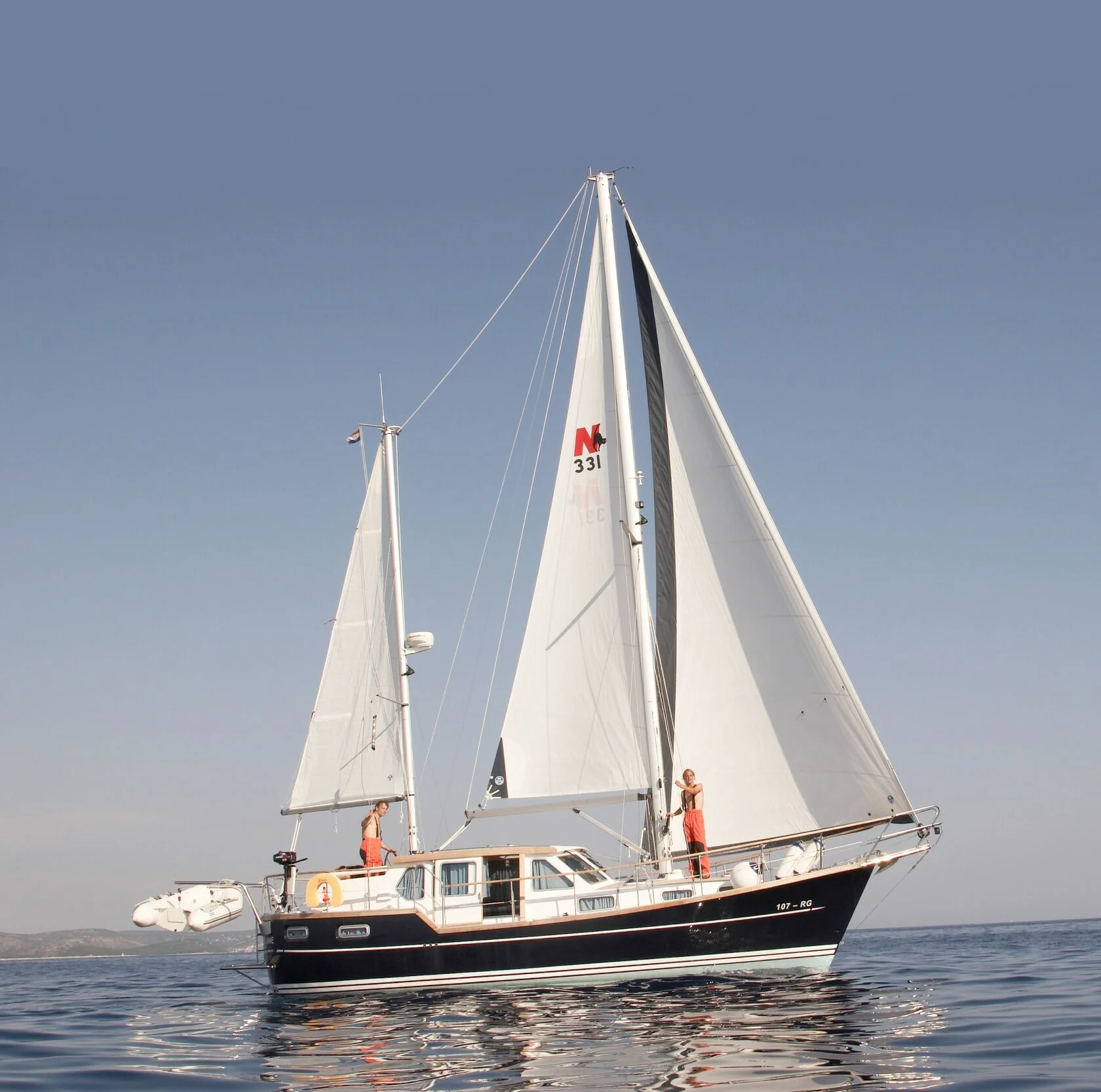 Nauticat 331 motorsailer with sails up on the coastal ocean