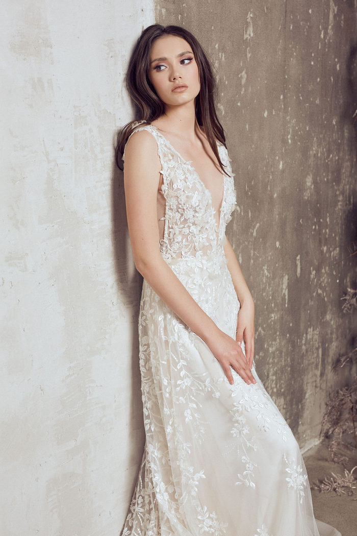 wedding dress designers - wed in florence -SLEEVELESS COUTURE BEADED LACE DRESS DECORATED WITH HAND CUT FLORAL DETAILS AND PETALS TO CREATE 3D EFFECT. LACE FALLS OVER OF NUDE TULLE LAYER FOR SOFT NUDE SHADE.