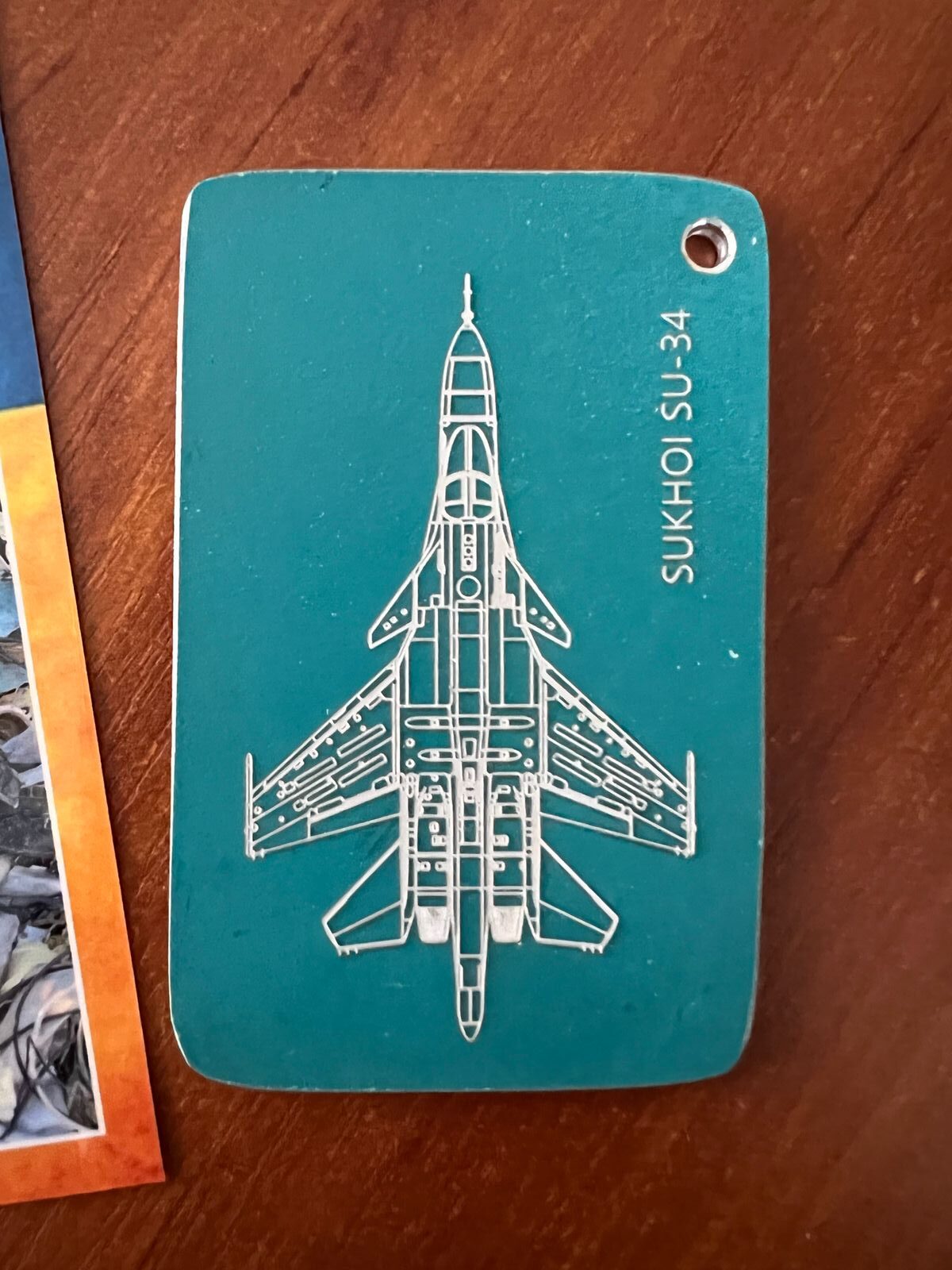 a blue tag with a picture of a jet on it